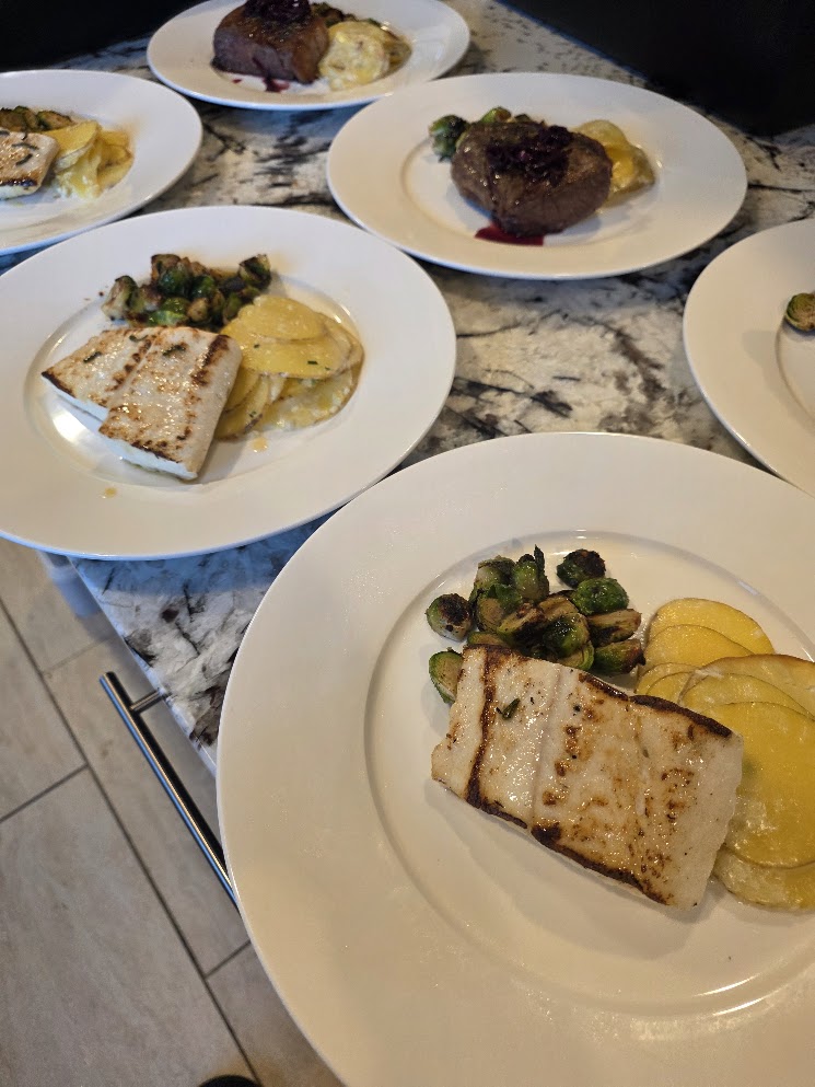 Halibut and steak entrées plated for private dinner guests