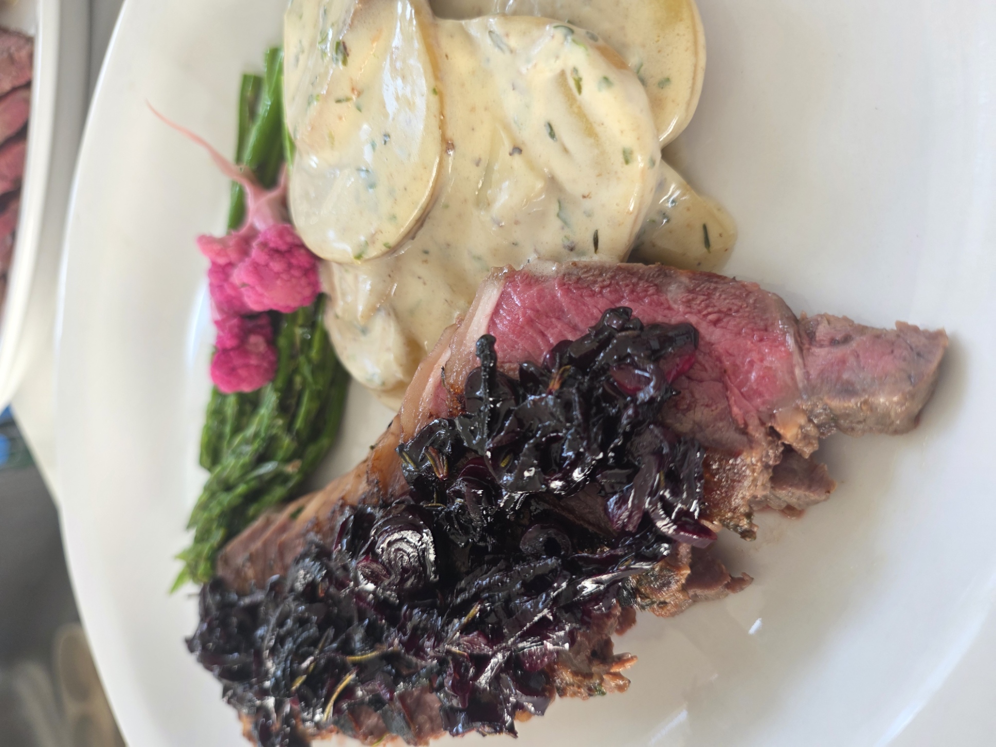 Herb-crusted New York strip with potato gratin